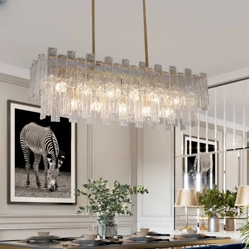A modern decorbites crystal chandelier with frosted glass panels and gold-toned metal for dining room light