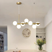 Modern brass pendant light with six frosted glass globe bulbs in linear design from decorbites postmodern collection