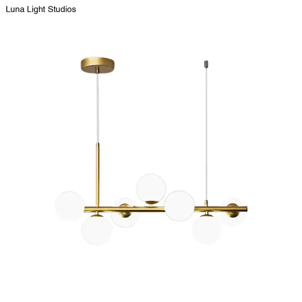DecorBites modern brass pendant light with clear glass globe shades in gold finish for kitchen lighting