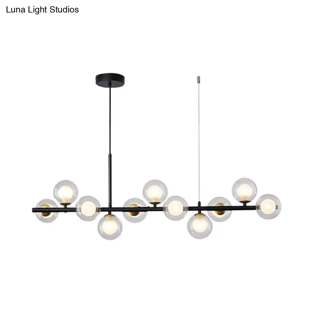 Black modern DecorBites pendant light with clear glass globe bulbs and brass accents for kitchen use