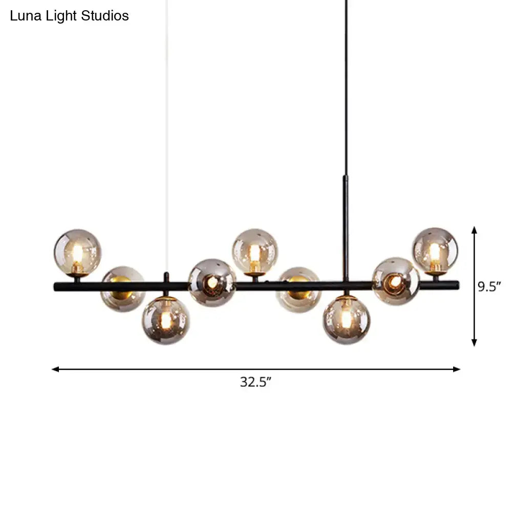 Black metal DecorBites™ pendant light with multiple warm glass ball bulbs in a postmodern design for kitchen use