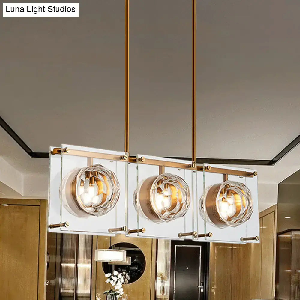 Postmodern gold and clear glass 3-light kitchen island light with rectangular brass rods and faceted crystal globe shades