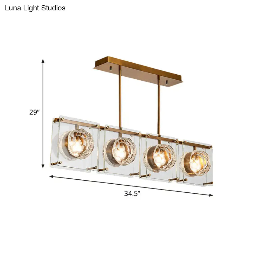 Modern brass-finished kitchen island light with four clear glass cubes and faceted crystal globe bulbs for island lighting