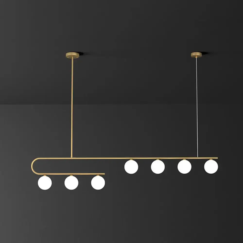 DecorBites™ modern brass island pendant light with five ivory glass bulbs in sleek curved LED hanging lamp design