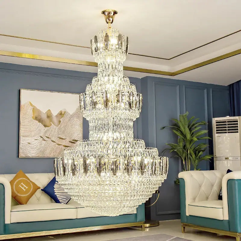 A multi-tiered decorbites crystal chandelier with gold-finished metal frame and cascading clear crystals for hotel lobby