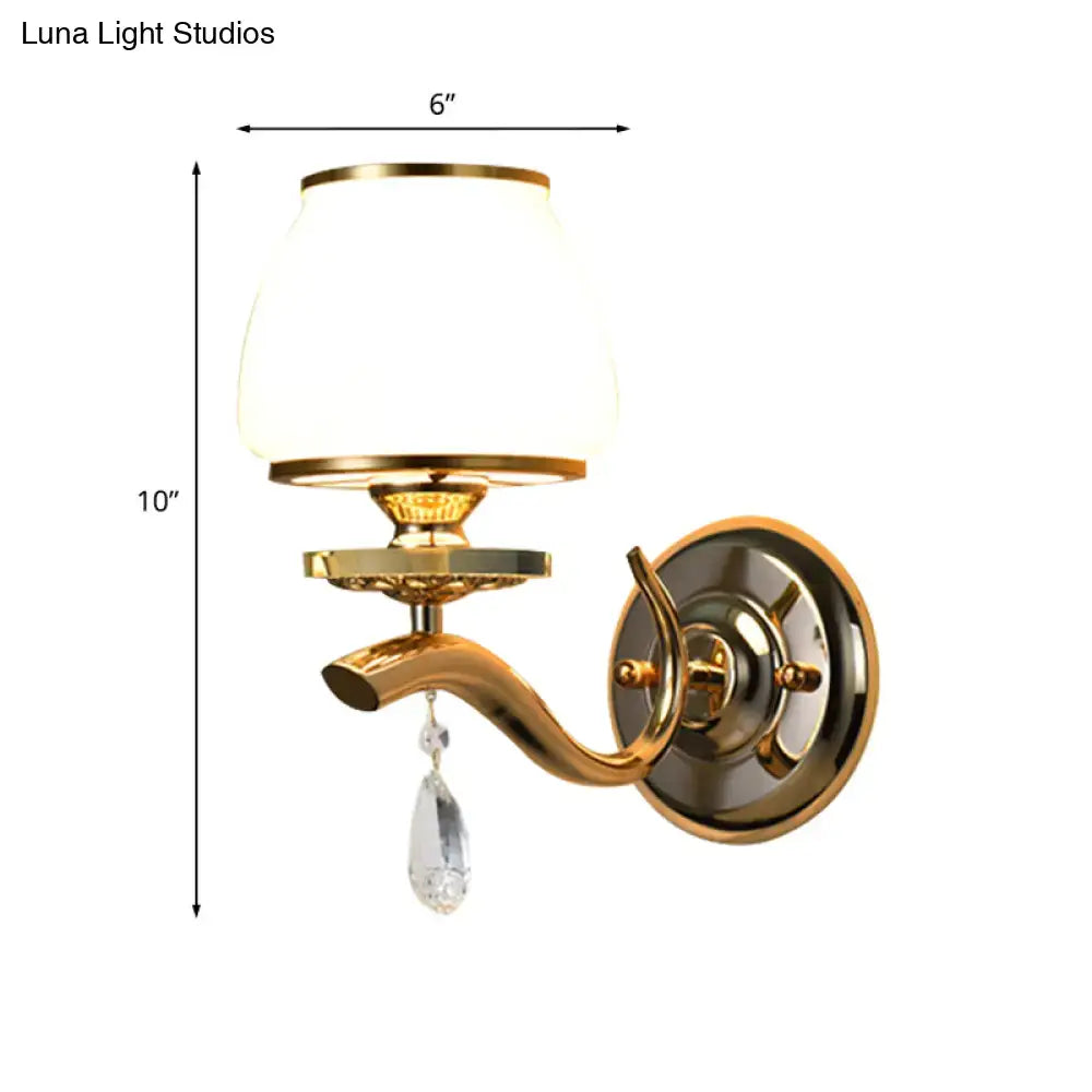 Postmodern gold finished wall sconce with white glass shade and crystal drop direct wired for bedroom lighting