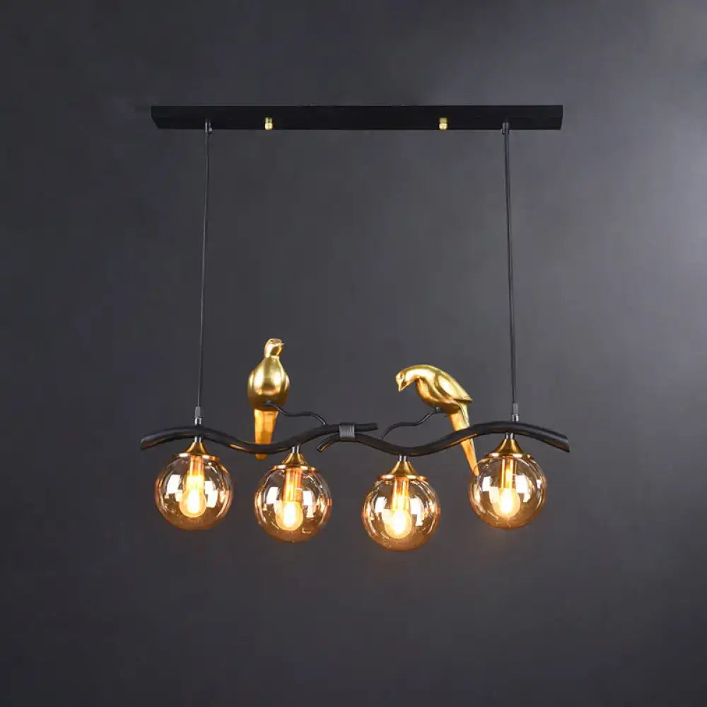 Gold-colored bird deco pendant light with amber glass globes and black metal branch for 110v-120v or 220v-240v use