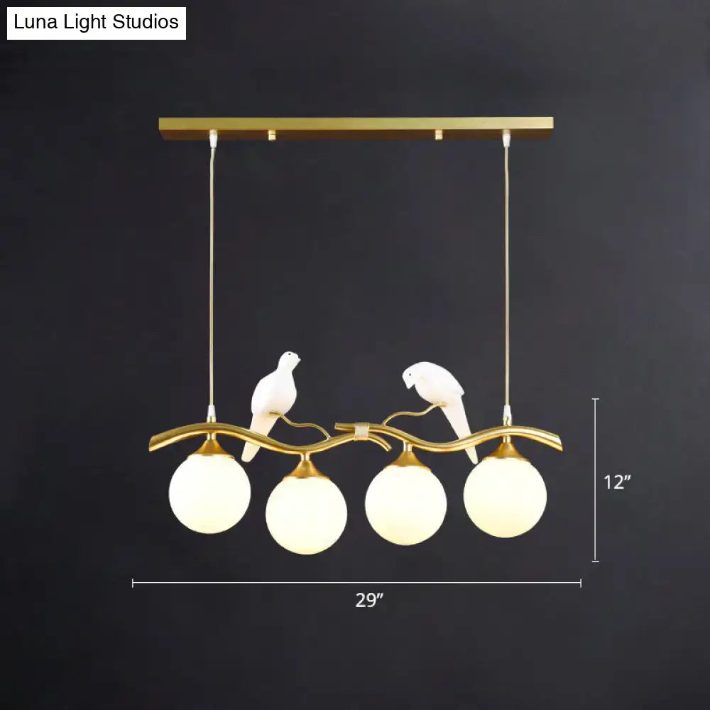 Gold-toned DecorBites™ sleek postmodern glass pendant light with bird deco and frosted globes 110v-120v 220v-240v compatible