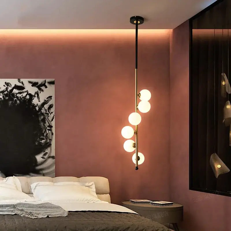 Postmodern gold and black glass floor lamp with sleek brass finish and five spherical bulbs in a vertical line