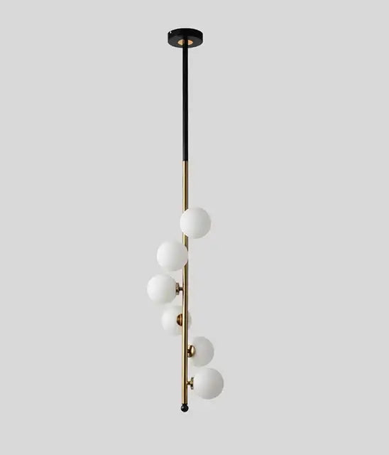 Postmodern gold and black glass floor lamp with sleek brass rod and six frosted glass spheres in cascading design