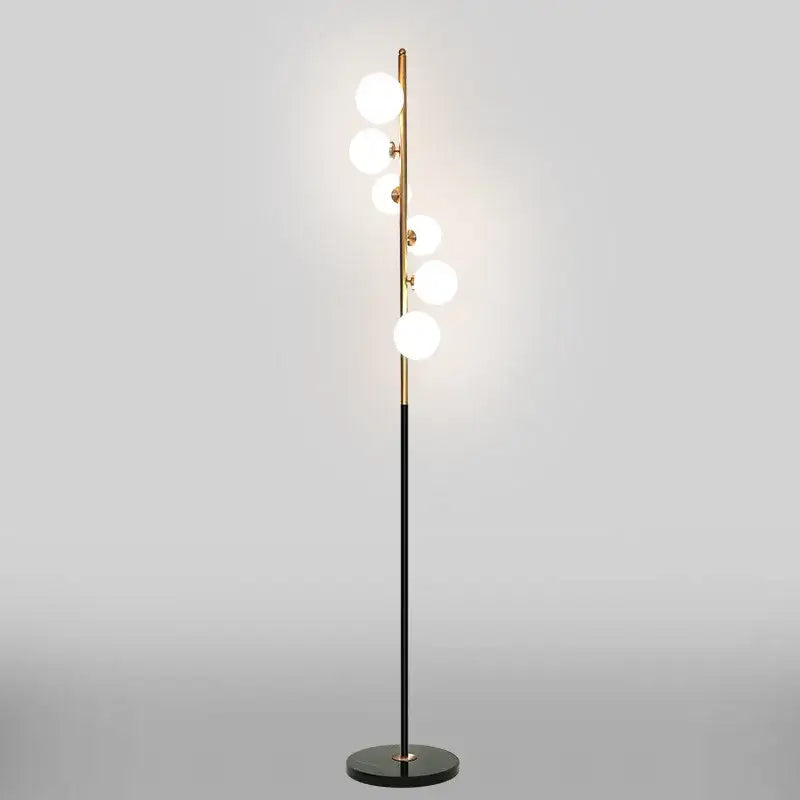 Postmodern gold and black glass floor lamp with five glowing white bulbs in a vertical cascade design for living room
