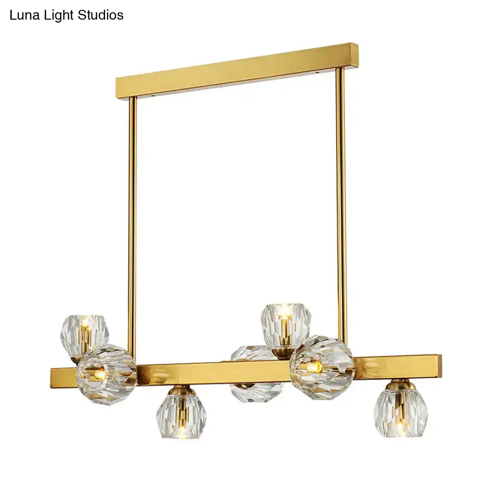 Gold-toned postmodern pendant light with faceted crystal globe shades in a gold branch design for island lighting