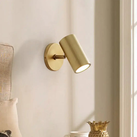 Postmodern gold brass tube wall light with cylindrical head and circular base 8 inches fixture for bedroom reading