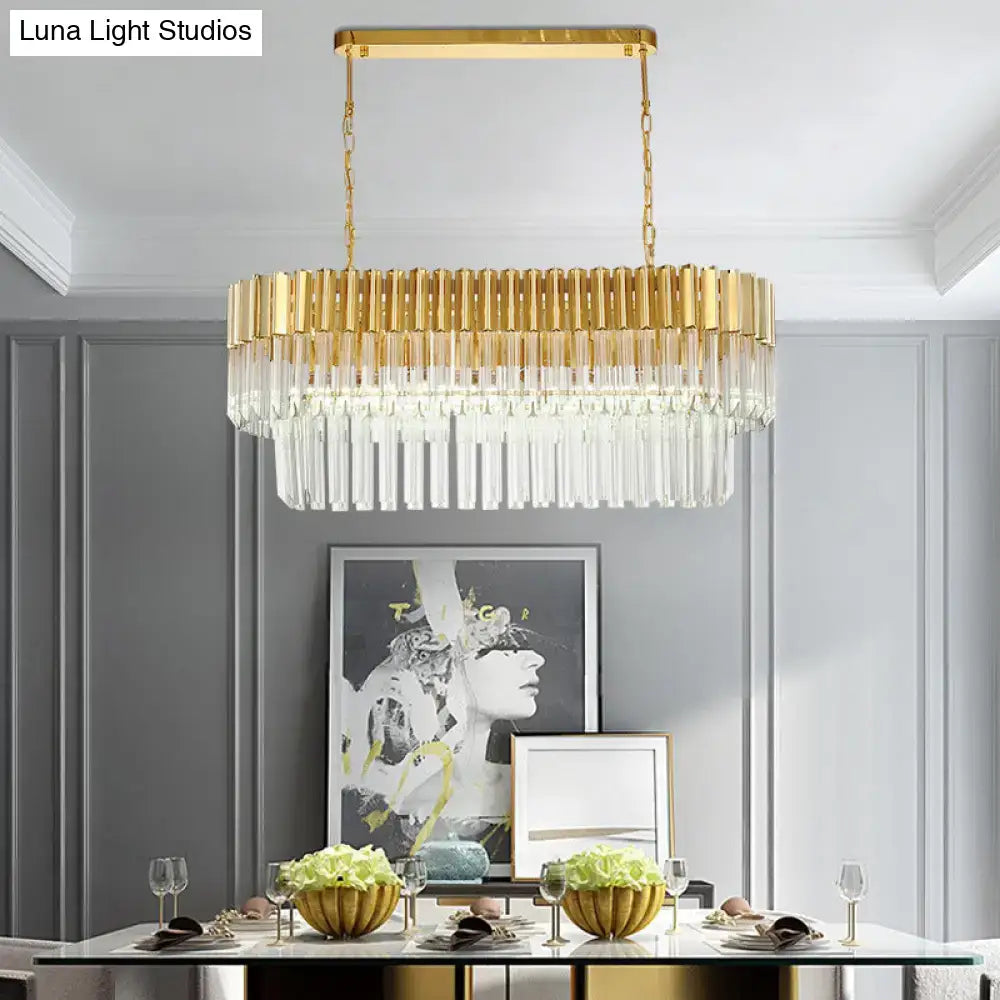 Postmodern gold-toned rectangular light fixture with cascading clear crystal prisms for dining room island lighting