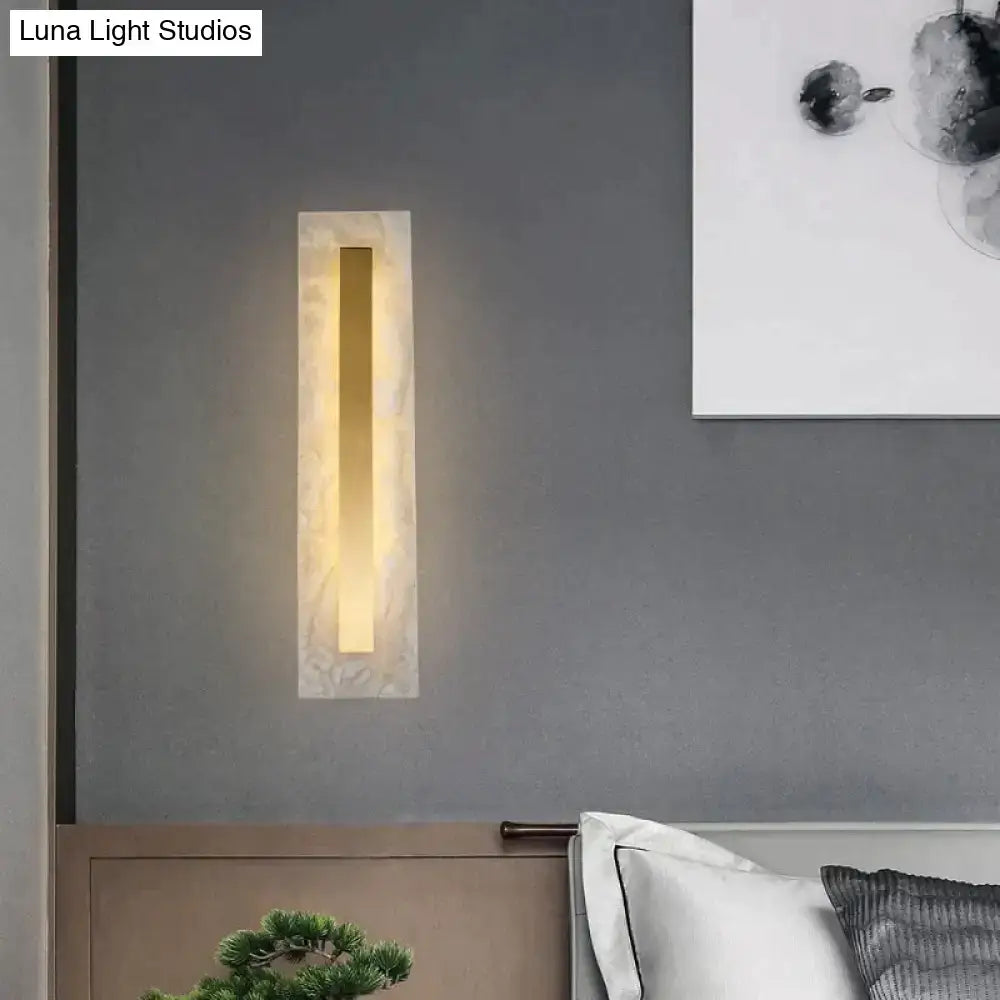 Postmodern gold copper marble wall lamp with warm light in a sleek white marble frame for living room use