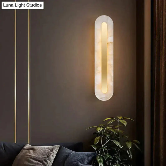 A postmodern marble wall lamp with a copper marble finish and warm golden light for living room use