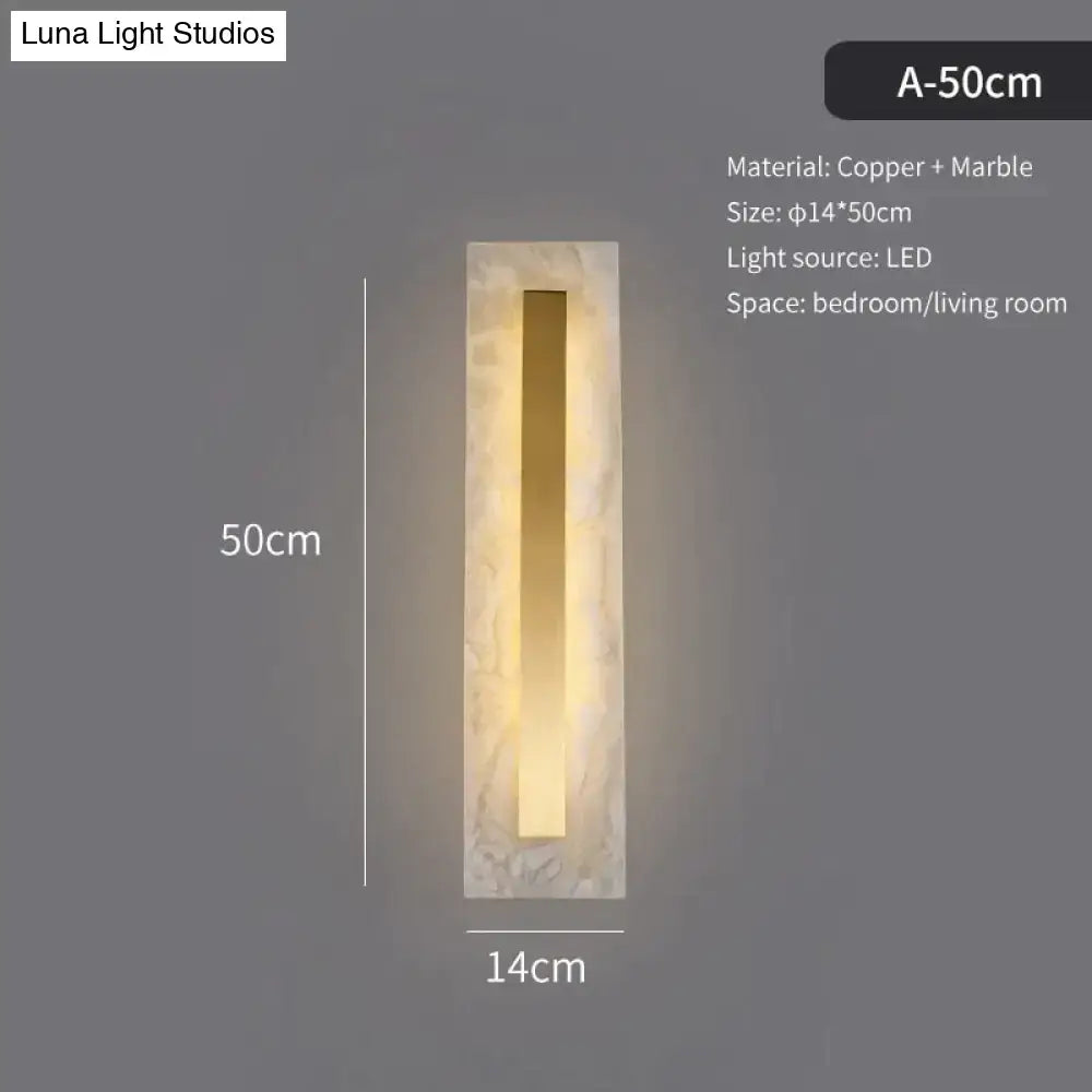 A sleek postmodern wall lamp featuring a copper marble wall bar within a textured white marble frame for living room