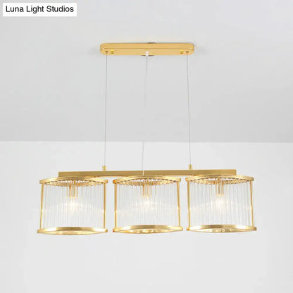 Postmodern gold crystal rod island light with three cylindrical glass shades and sleek metal frame for dining room