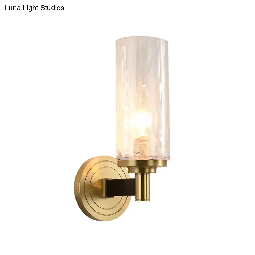 A modern postmodern gold crystal wall mounted light with brass and translucent textured glass for living room use