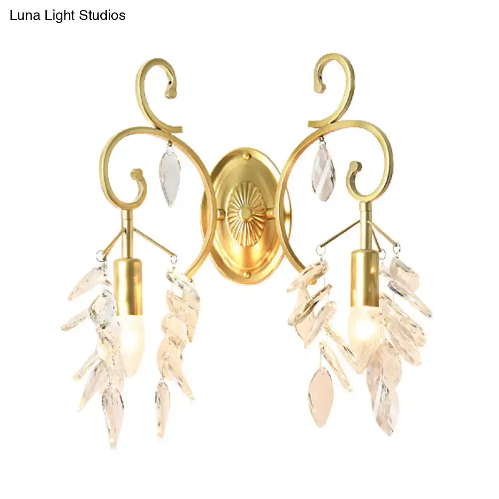 Gold curve arm sconce light with ornate scrollwork and crystal leaf accents for elegant living room lighting