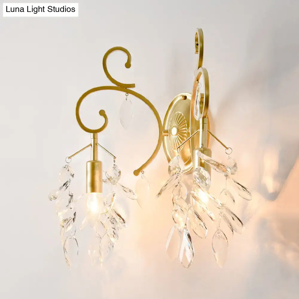 Postmodern gold curve arm sconce light with ornate curved arms and crystal leaf accents for living room use