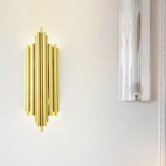Postmodern gold finish flute wall mount sconce with gold-toned vertical cylindrical tubes in a symmetrical radiating pattern