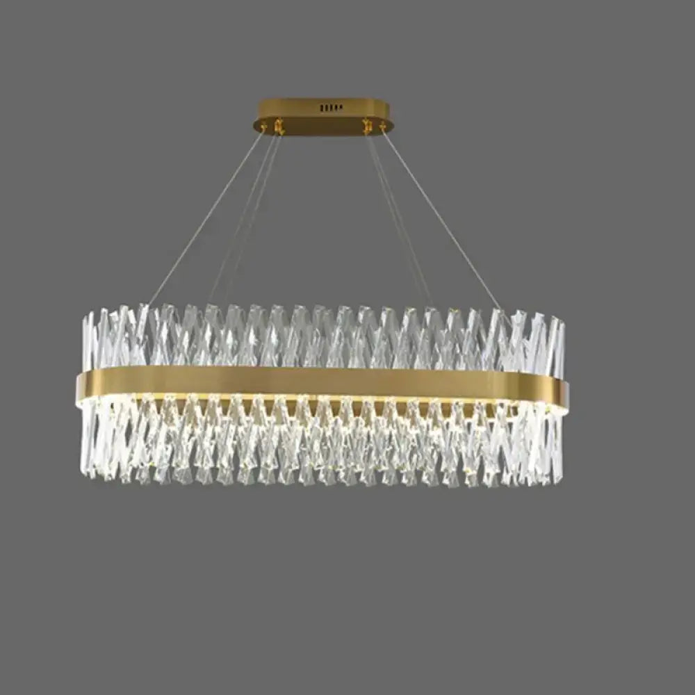 Postmodern gold finish pendant light with geometric k9 crystal prisms and illuminated central band for bedroom use