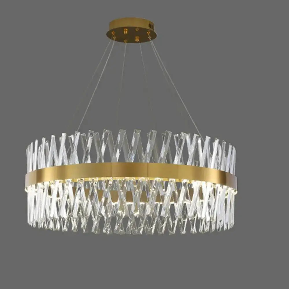 Postmodern pendant light with gold finish and geometric k9 crystal prisms in an interlocking x-pattern fixture width