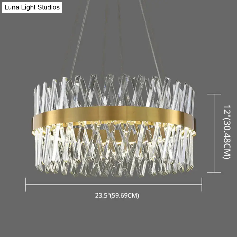 A modern circular pendant light with gold finish metal ring and k9 crystal prisms ideal for bedroom fixture width