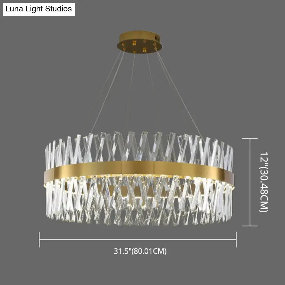A postmodern gold finish pendant light with geometric k9 crystal elements and an interlocking circular frame fixture width