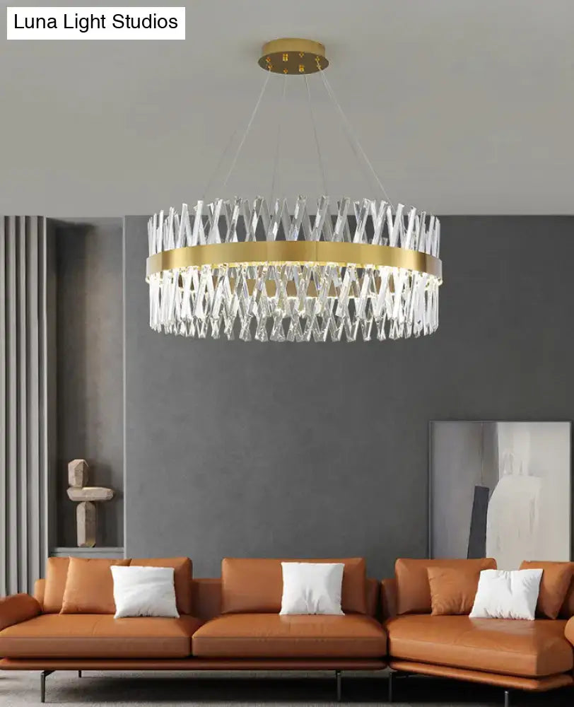 A modern circular pendant light with gold finish and k9 crystal geometric design for bedroom fixture width