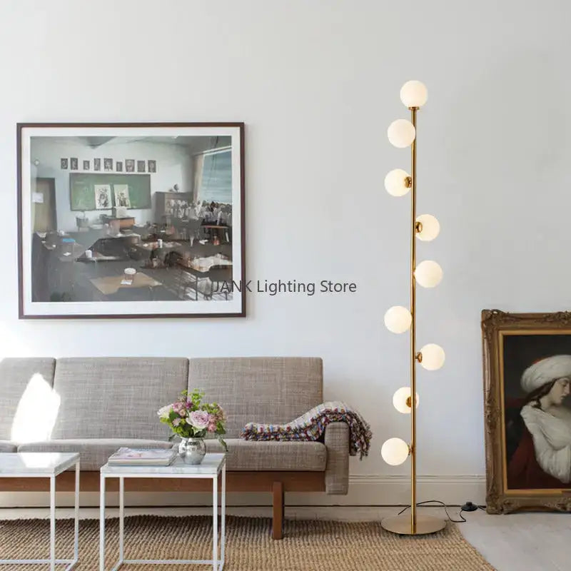 Postmodern gold glass ball standing lamp with seven white glass bulbs on a slender metallic pole for living room decorbites glass ball