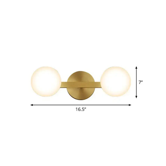 Brass-finished postmodern wall sconce with two frosted glass globes and 11in fixture height for bulb base use