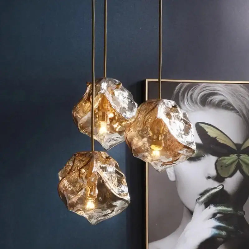 Three amber-tinted frosted glass led chandelier pendants with irregular shapes for postmodern dining room lighting