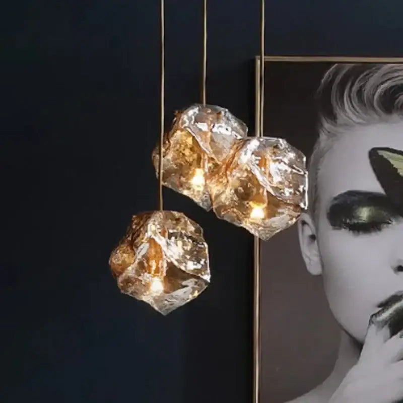 Postmodern gold irregular glass led chandelier with three hanging crystal pendant lights and gold-toned cords for dining room