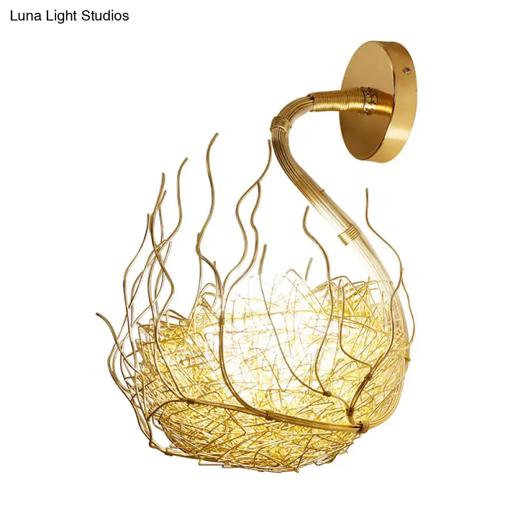 Postmodern gold-toned wire nest globe glass wall light fixture with intricate flame-like wirework and warm glowing interior