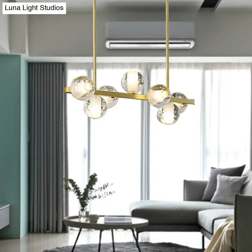 Modern gold-toned DecorBites™ postmodern seeded crystal suspension globe light with six frosted glass spheres for dining rooms