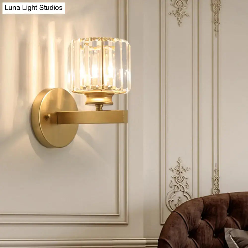 Postmodern gold wall lamp with prismatic crystal shade featuring a faceted crystal glass bedroom sconce