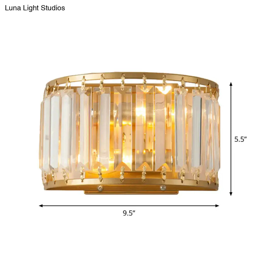 Postmodern gold wall lamp with prismatic crystal shade featuring vertical crystal bars and dangling clear crystals for bedroom use