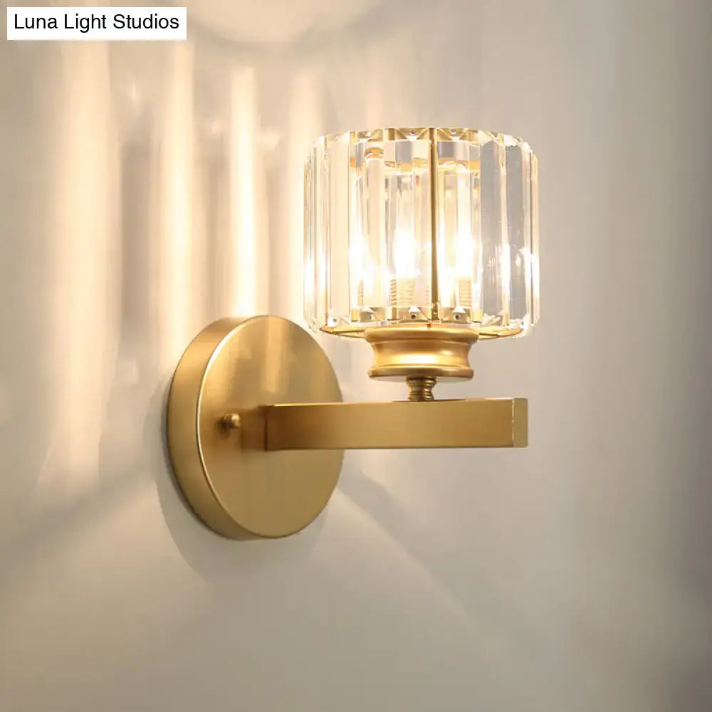Postmodern gold wall lamp with a gold-toned body and prismatic crystal shade for bedroom use