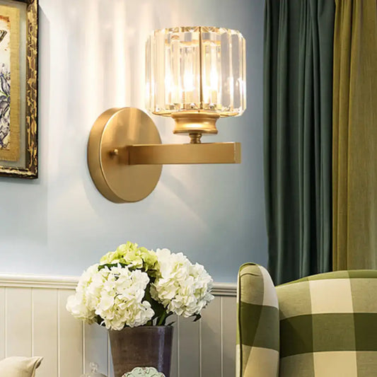 Postmodern gold wall lamp with prismatic crystal shade featuring a faceted crystal design for bedroom sconce lighting