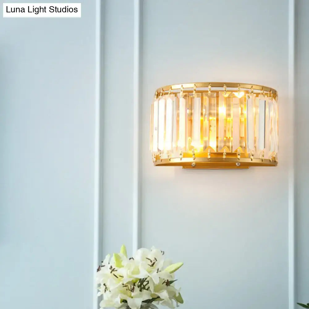 Postmodern gold wall lamp featuring a prismatic crystal shade with vertical crystal rods in a circular frame