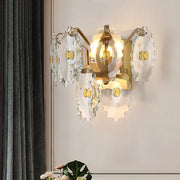 Elegant green gold gem wall sconce with translucent scalloped glass petals and amber accents, ideal bedroom light fixture