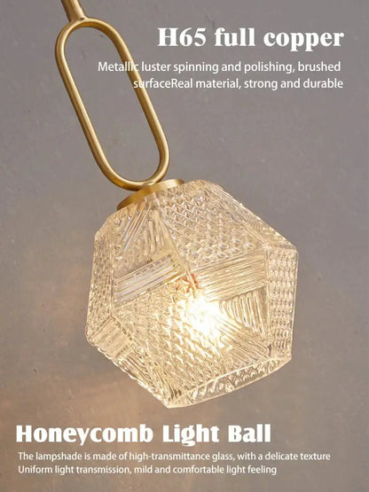 Postmodern luxury led wall lamp with hexagonal honeycomb glass lampshade and brushed brass copper chain in gold crystal design