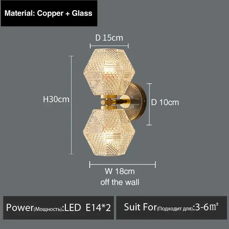 A modern copper and glass postmodern luxury led wall lamp with two hexagonal faceted crystal shades for bedroom light