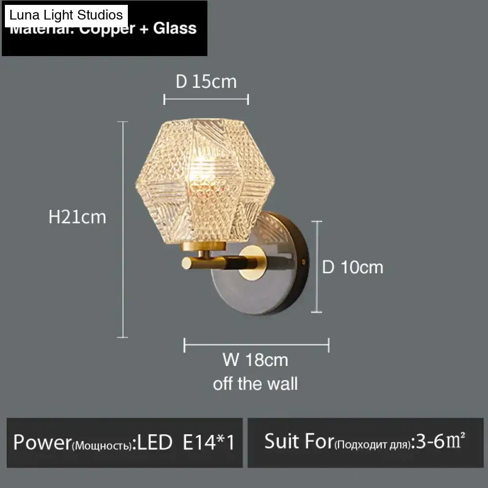 A postmodern luxury led wall lamp with a hexagonal gold crystal glass shade and copper mounting bracket for bedroom use