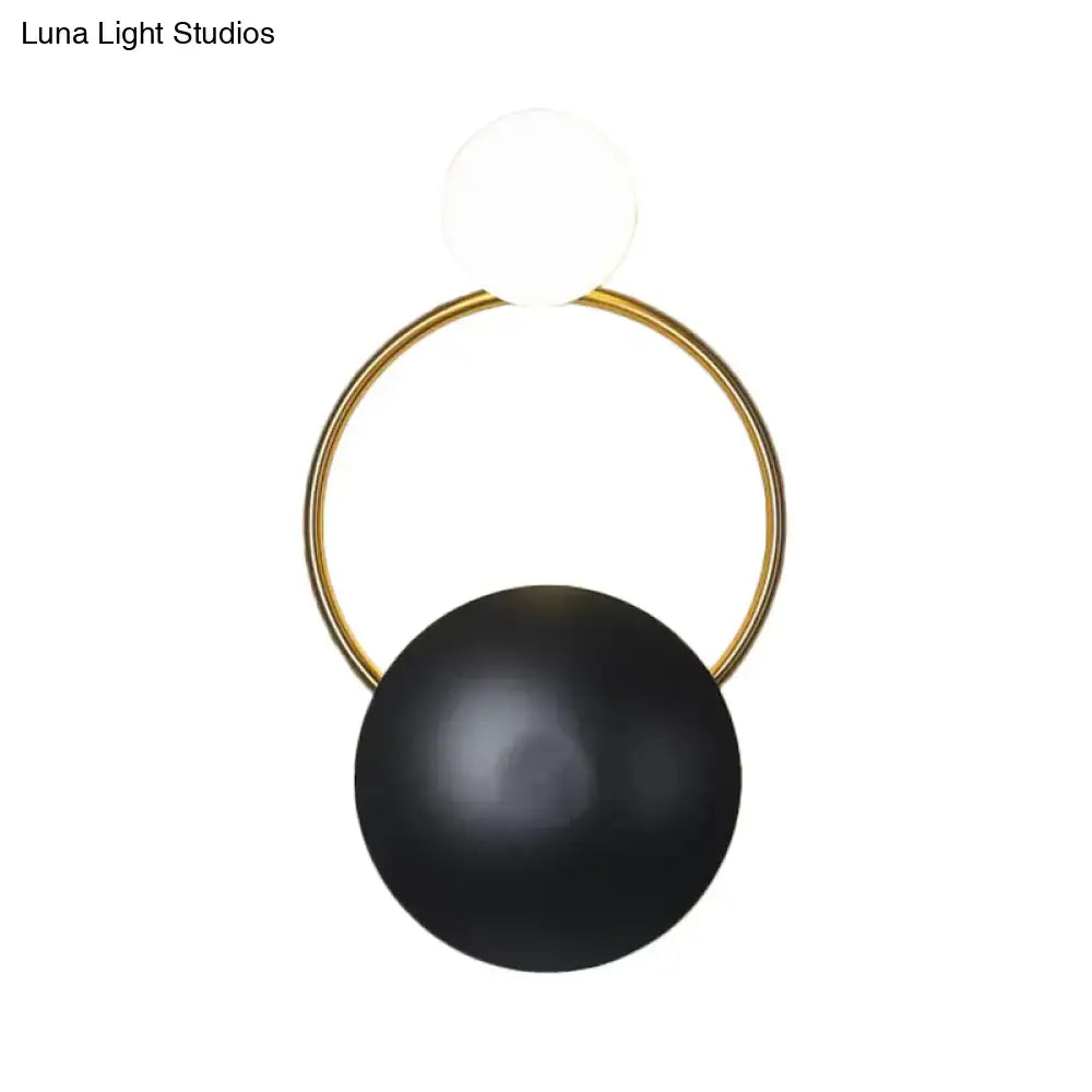 Postmodern orbital flush mount wall sconce with gold-toned circular frame and black and white spherical elements for bedroom