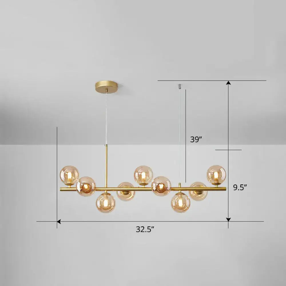 Gold-toned DecorBites™ LED island pendant light with amber glass globes in clear smoke grey for dining room lighting