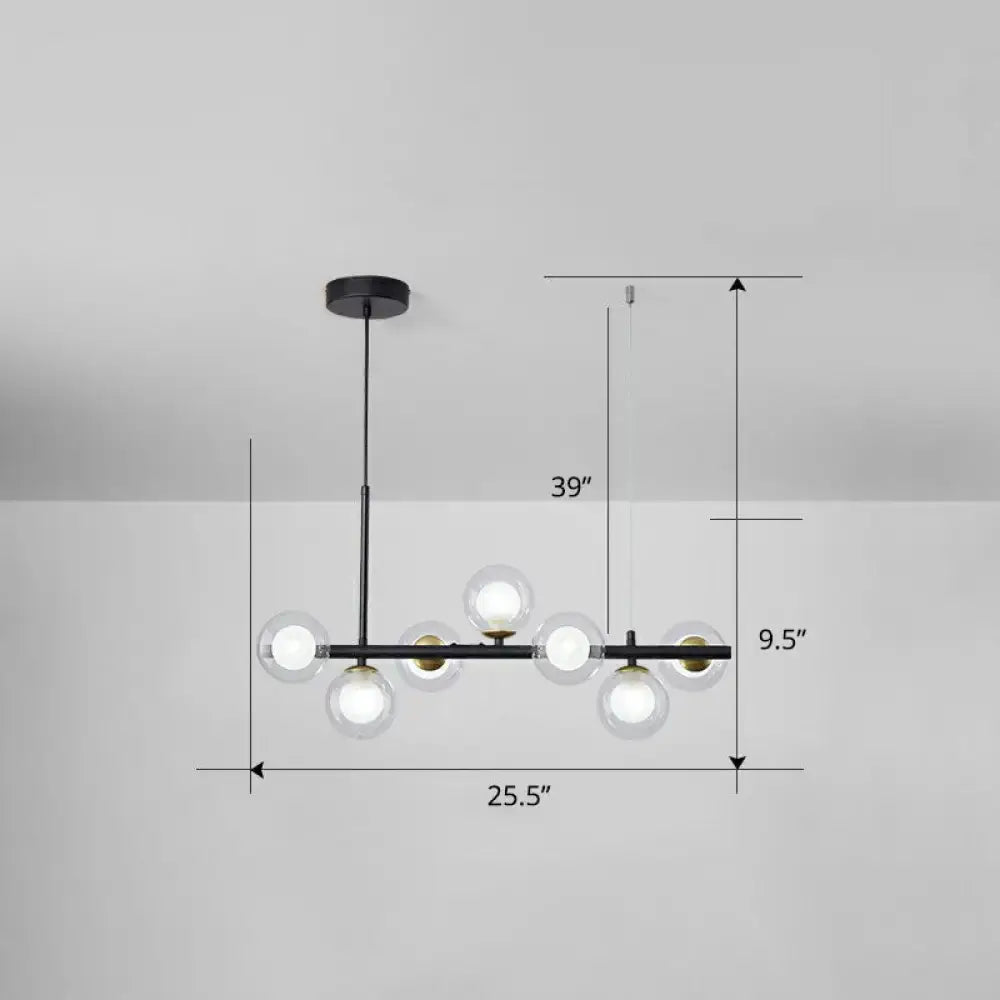 Modern black metal chandelier with six clear glass globe bulbs and brass accents for dining room lighting with smoke grey cognac details