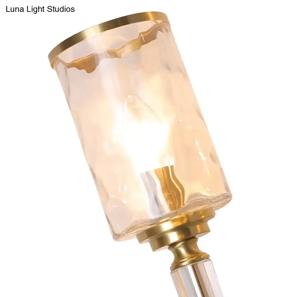 Postmodern water glass brass wall light with warm amber textured glass and polished brass accents for bedroom use